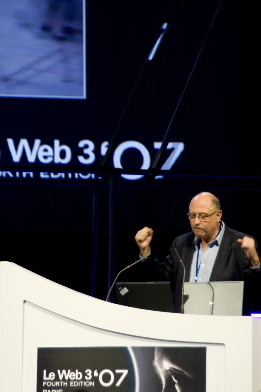 a man standing at a podium giving a speech