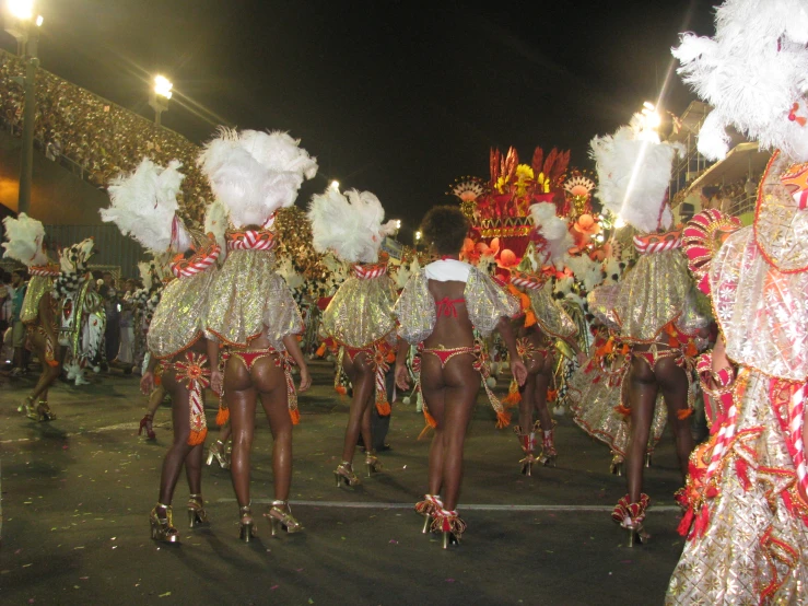 performers dressed in colorful costumes are walking through the street