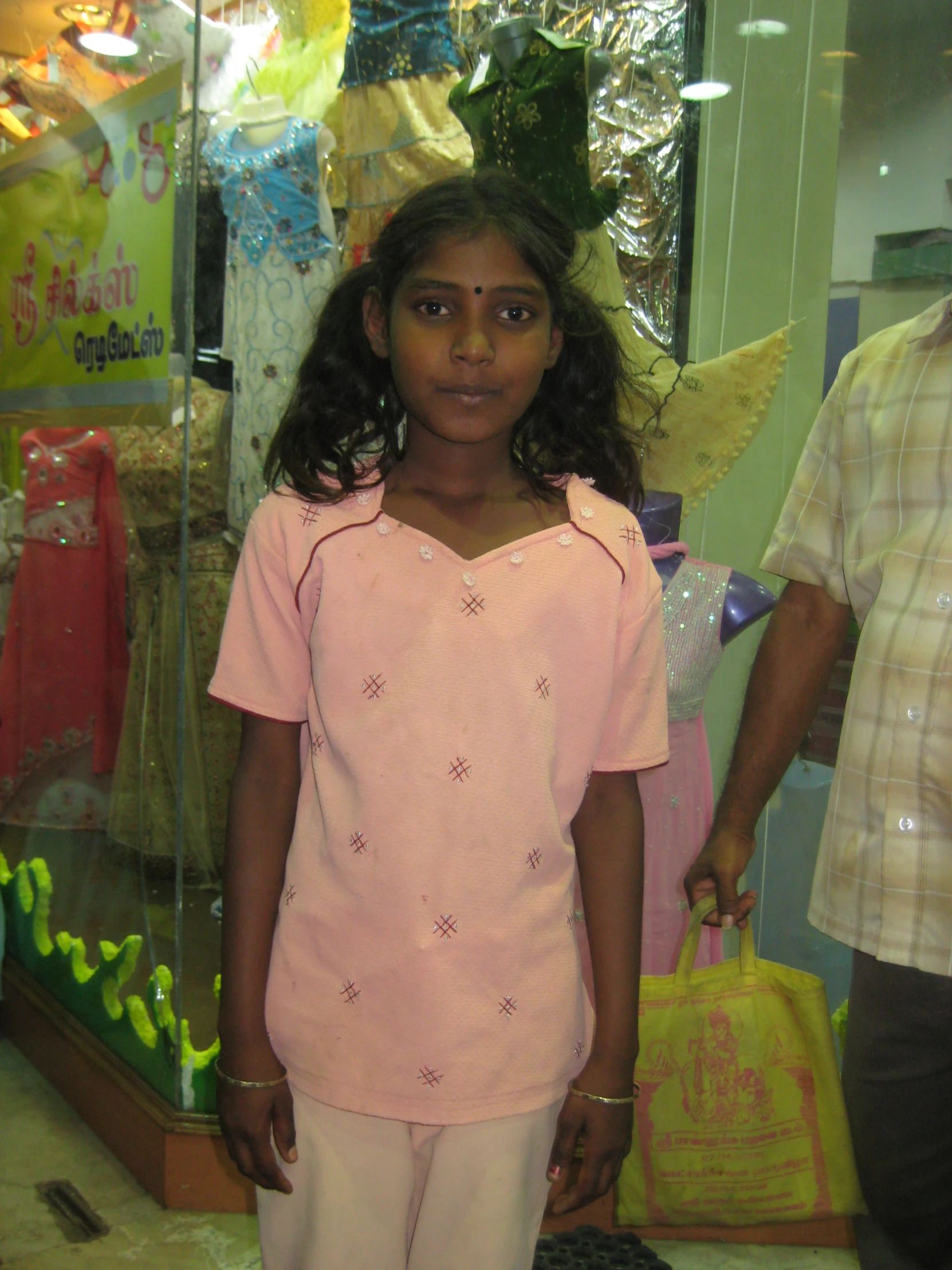 a little girl that is standing up by a window