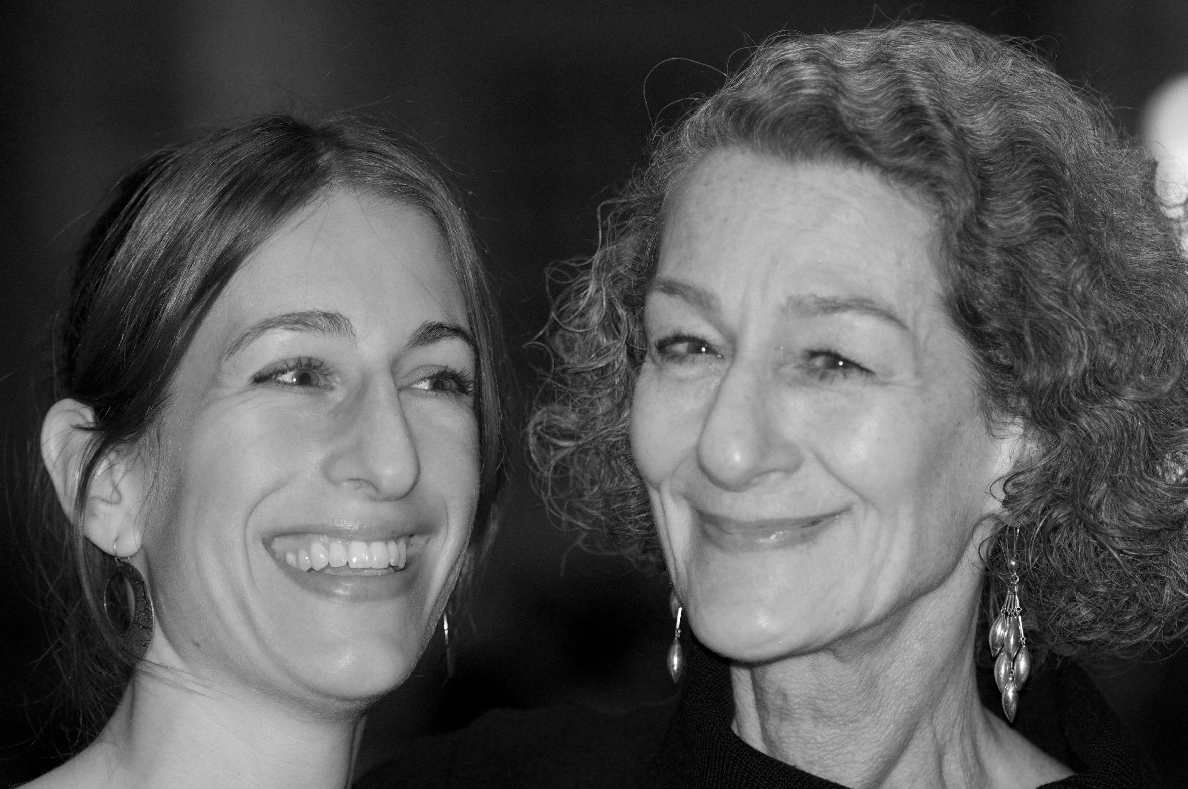 two women smile as they pose for the camera