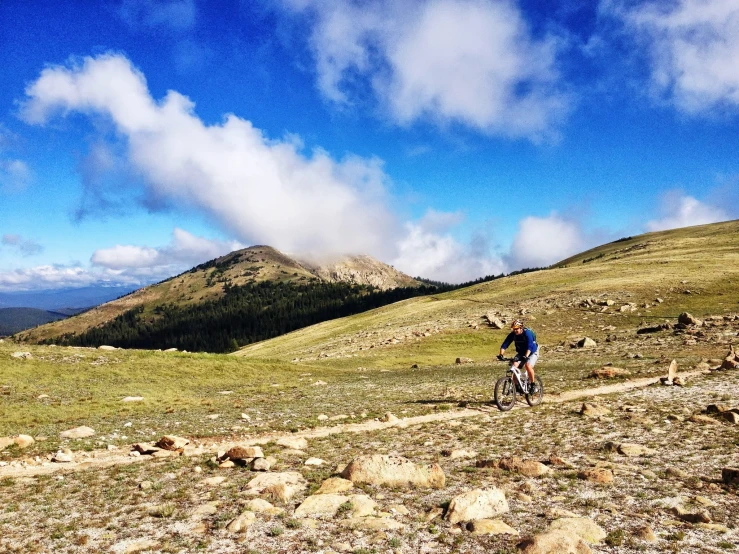 the person is riding a bike up a mountain