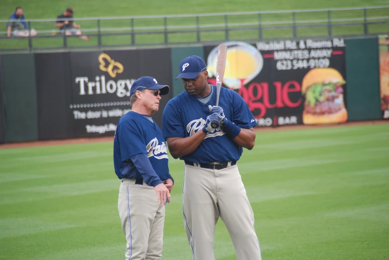 a couple of baseball players are talking on the field