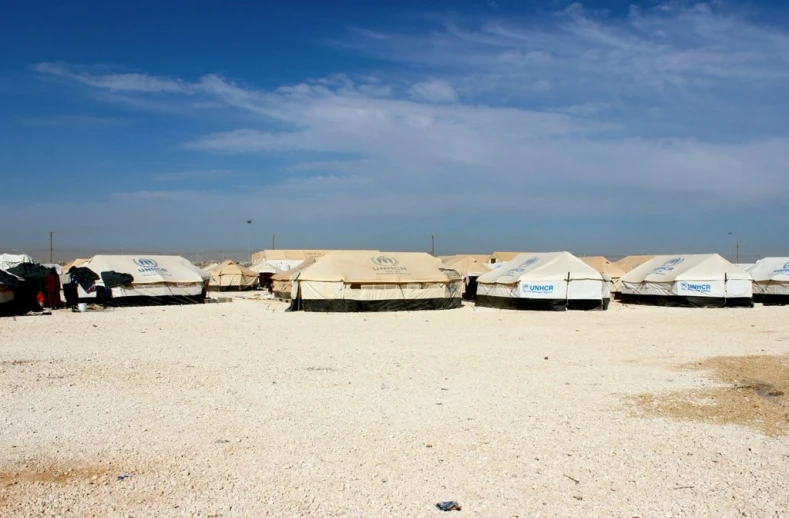 several boats lined up on a sandy beach