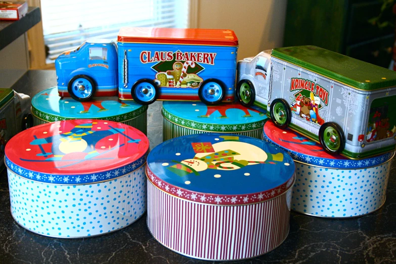 a bunch of colorful tin containers that are on top of a table