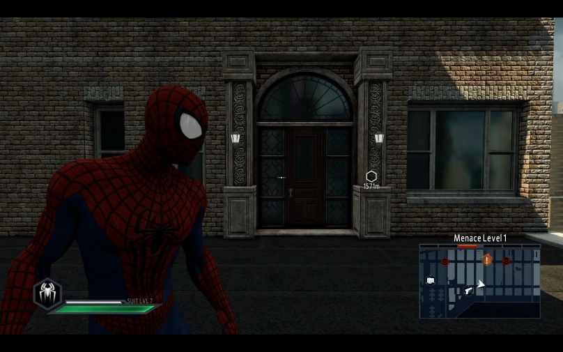 the spiderman from a computer game, in front of a brick building