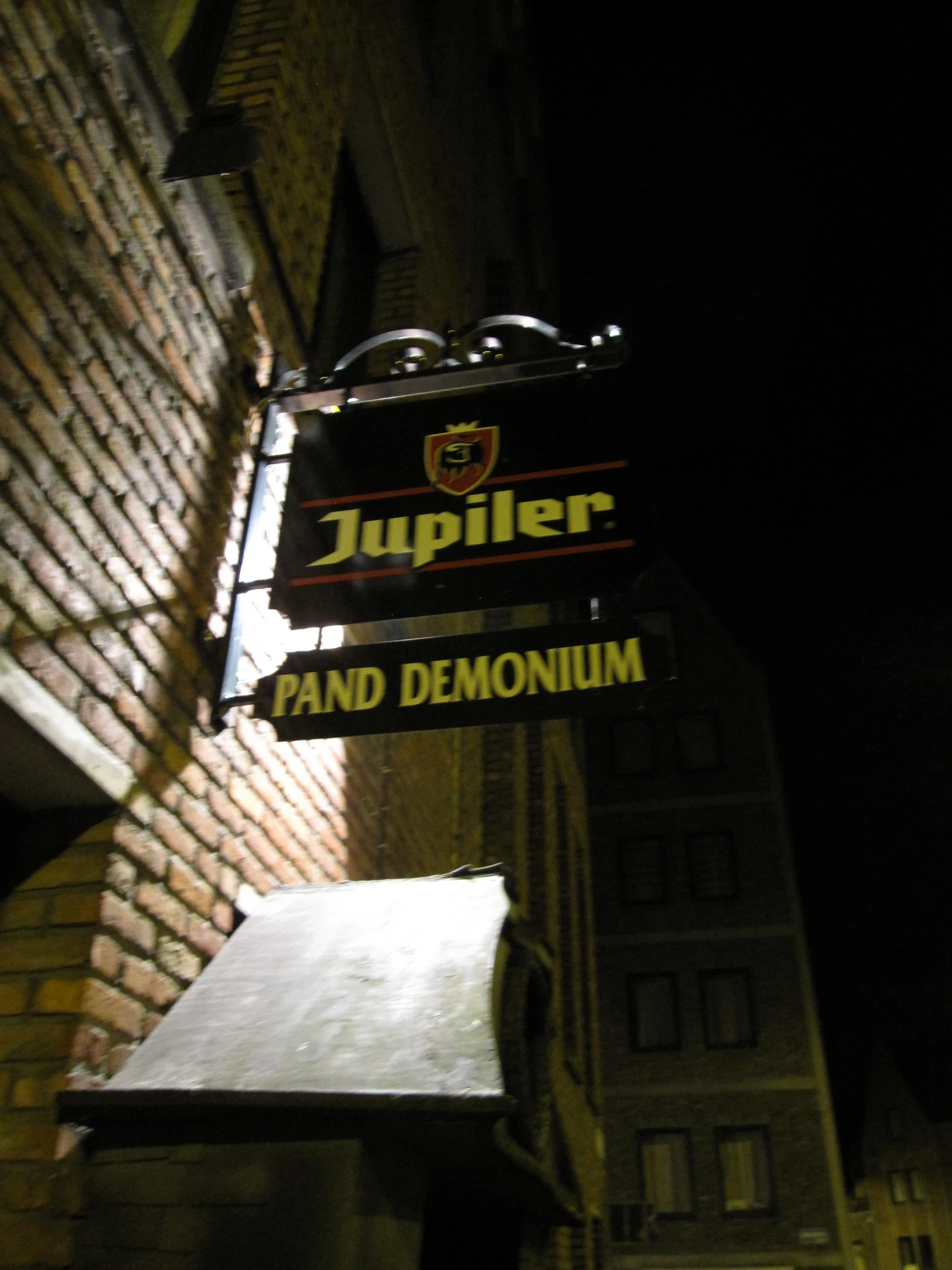 a restaurant sign in the middle of an alley