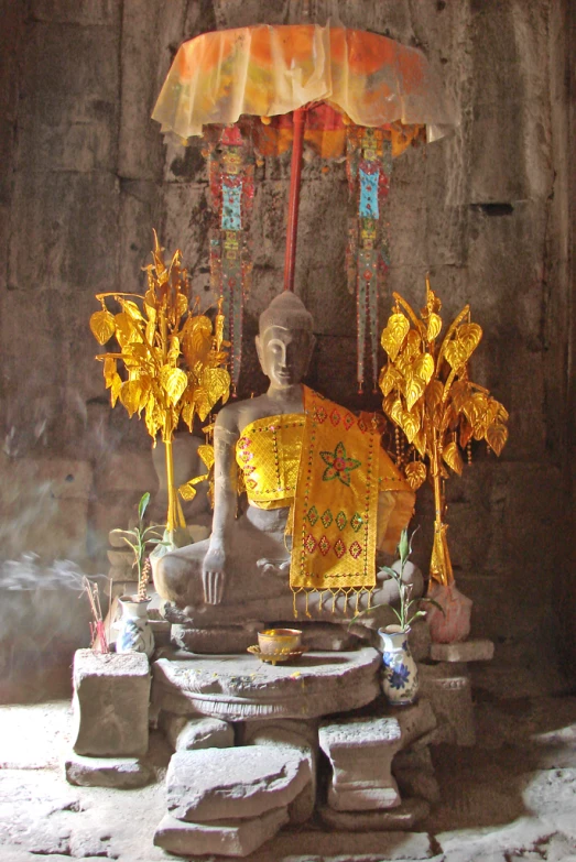 an ancient statue has a large white umbrella