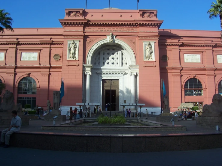 an old building that has a fountain near by