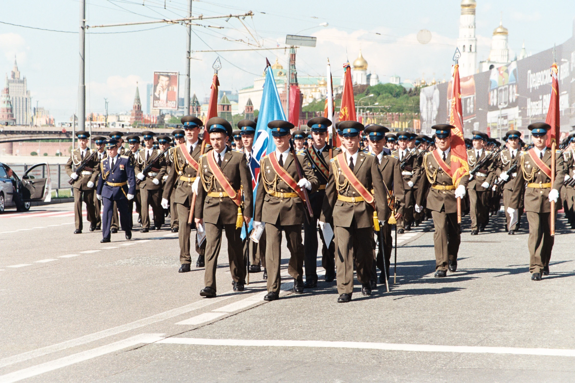 a parade with military men marching down the street