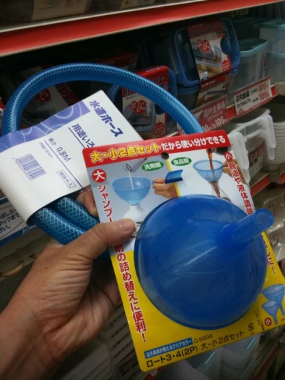 a person holding a plastic item with the handles and packaging