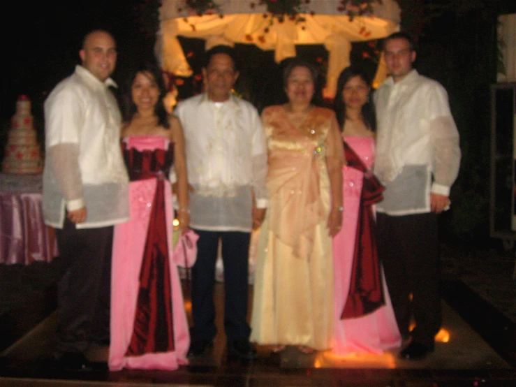 a family posing in formal dress for a picture