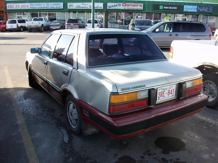 an old car is parked in the parking lot