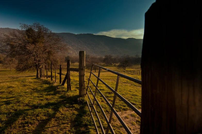 wooden fence with mountains in the background