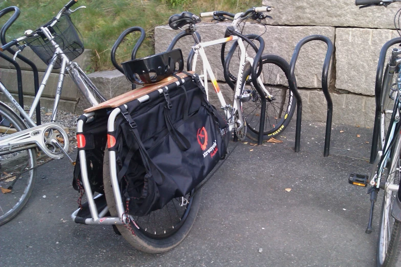 several bikes with bicycles are parked on the side of the road