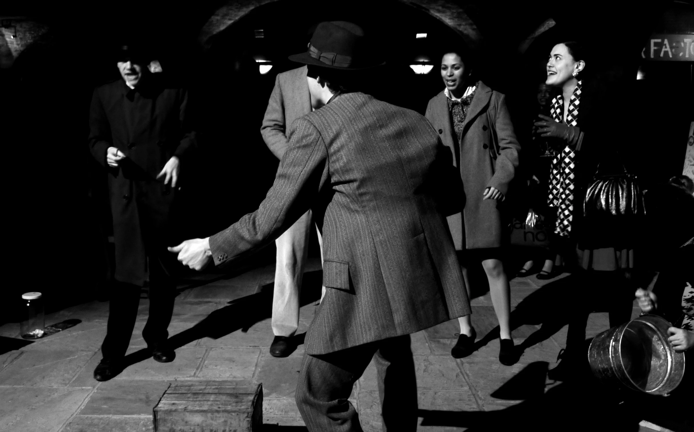 several people standing in front of a tunnel