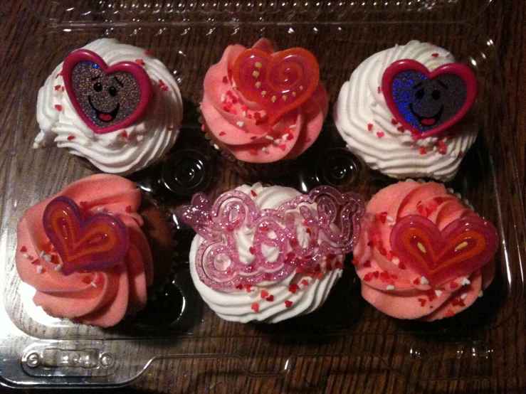 several heart shaped cupcakes in plastic wrappers