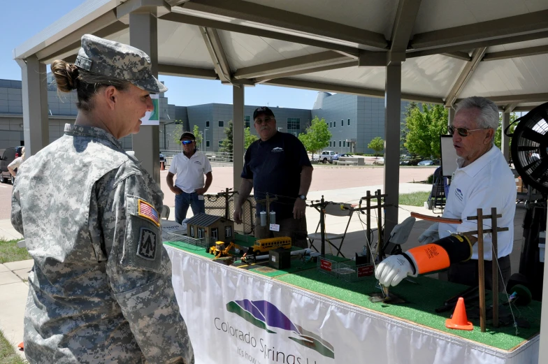 a soldier is looking at a machine in the table