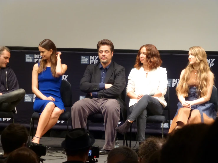 three actors are sitting in chairs during a panel