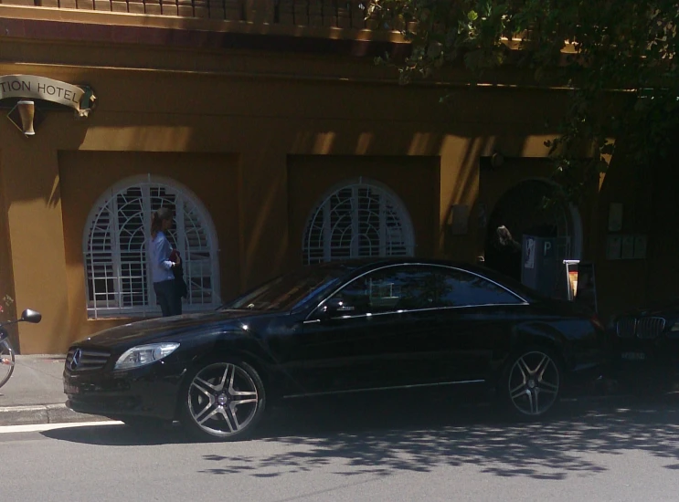 a car parked next to a building on a street