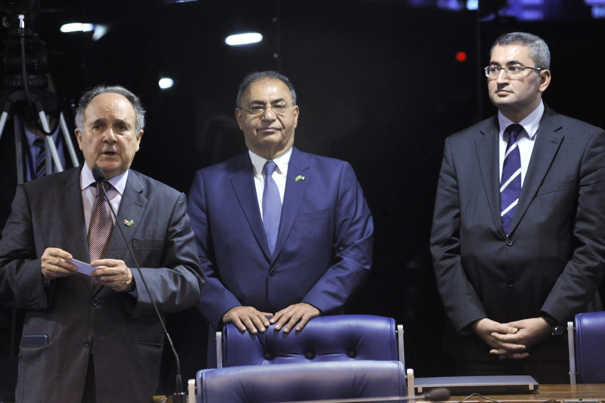 a group of people standing around a room