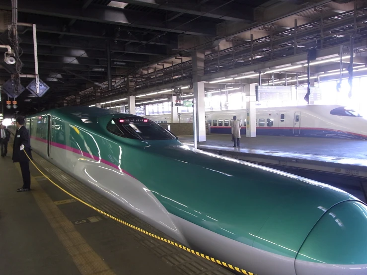 a modern commuter train in the middle of a station