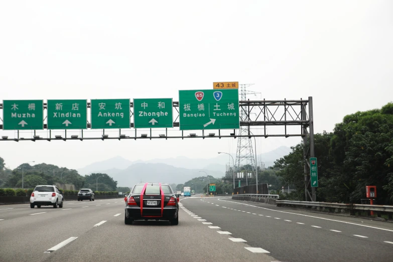 two cars and four pedestrians on a highway