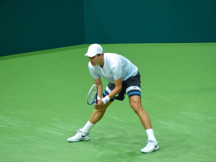 the man is preparing to serve the tennis ball