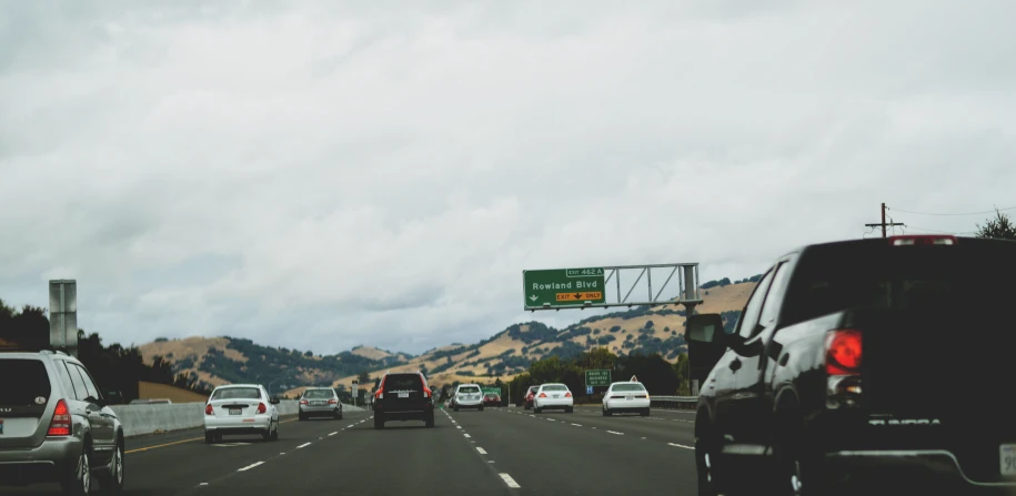 a street filled with traffic under overpass