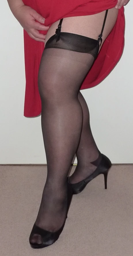 a woman wearing tight, black and red stockings