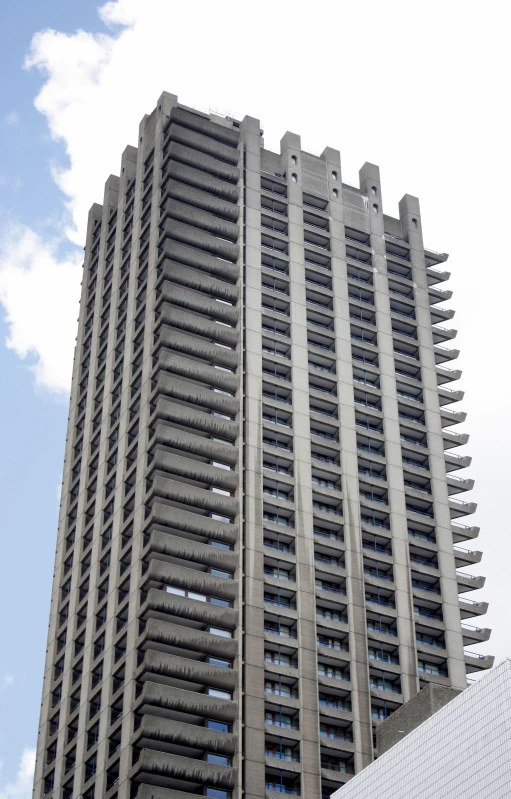 a very tall building sitting in front of a blue sky