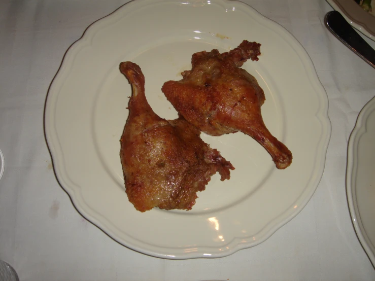 two pieces of chicken are sitting on a plate