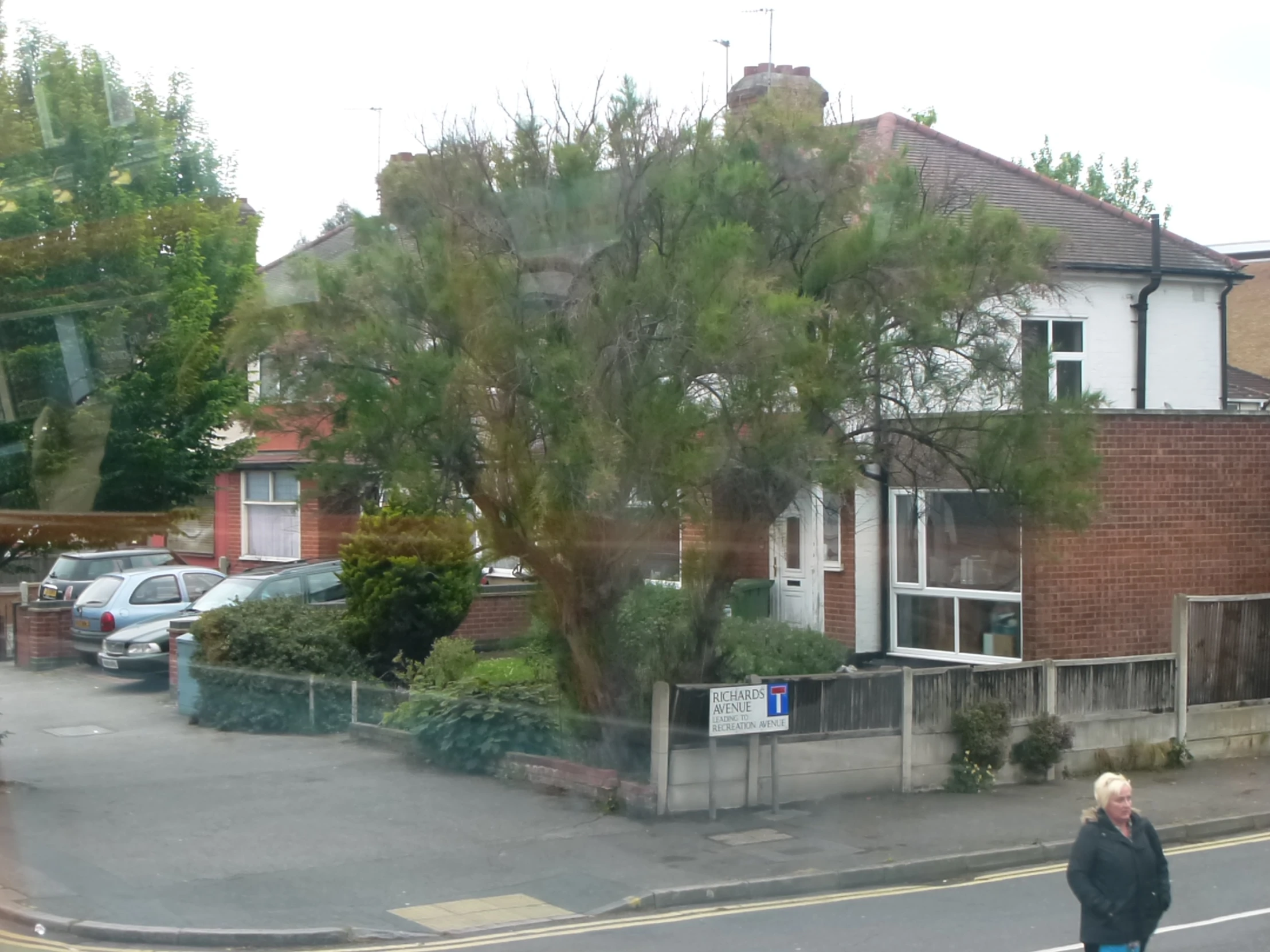 this is an image of a street with cars parked on the side