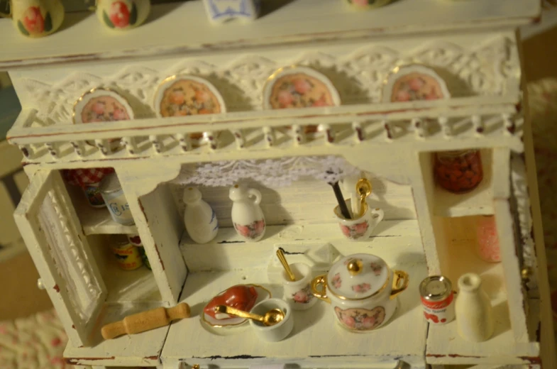 there is a doll's tea set in the dollhouse