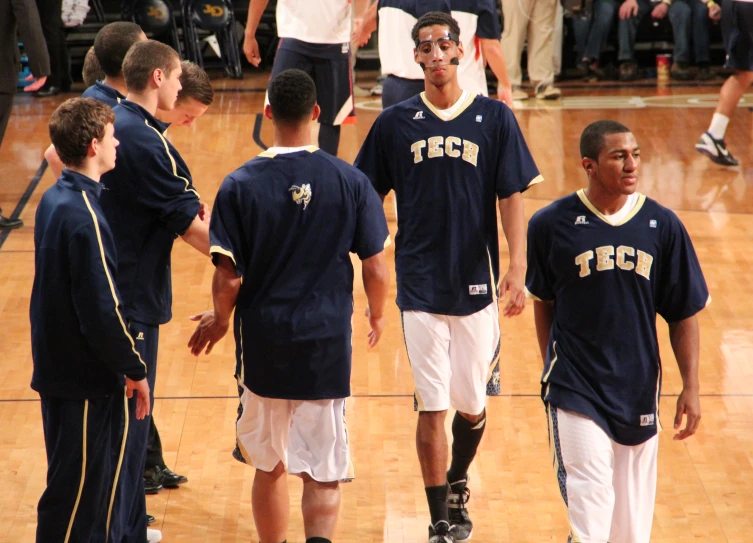 a group of basketball players standing on a court