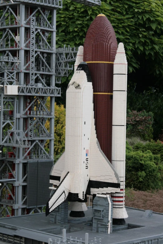 the model of a white rocket sits on display