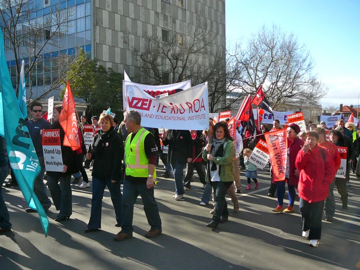 several people walking and carrying protest signs