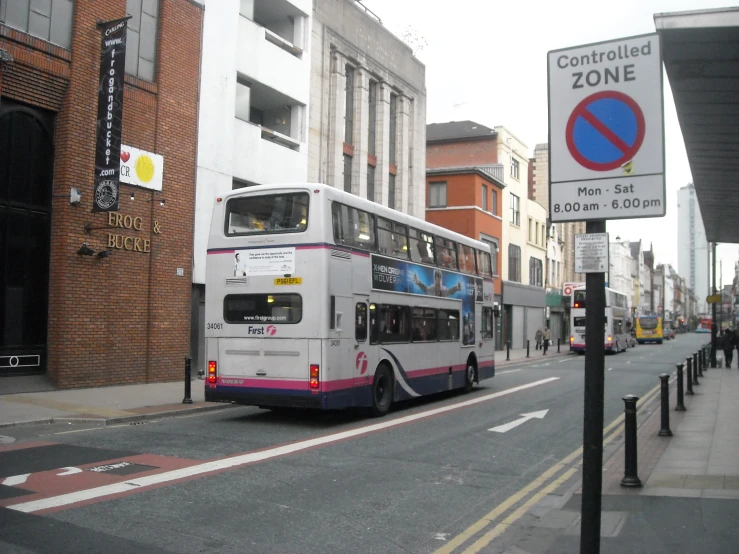 a double decker bus is parked next to the curb