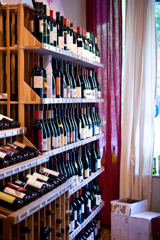 a bunch of bottles of wine are on the shelves
