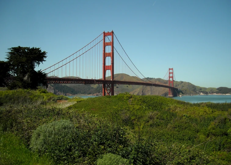 the golden gate bridge with mountains in the background