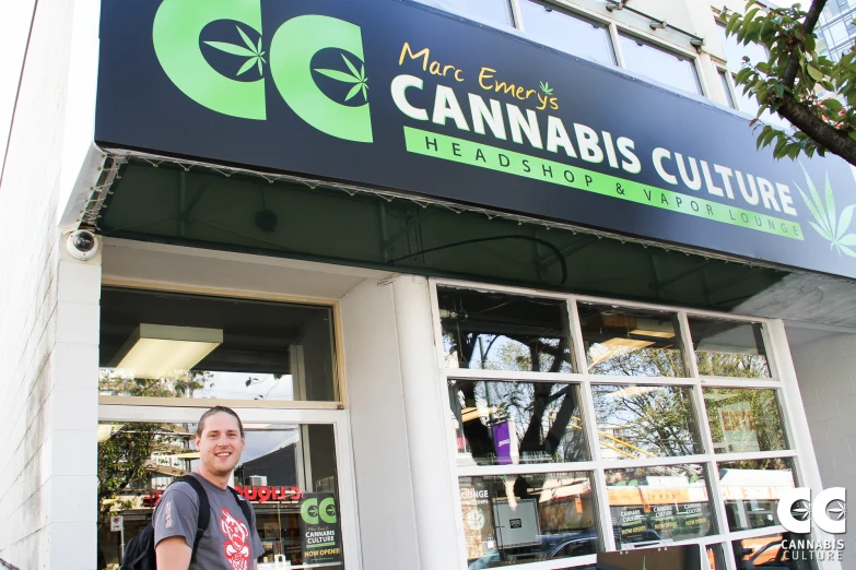 a man standing outside of a cannabis store