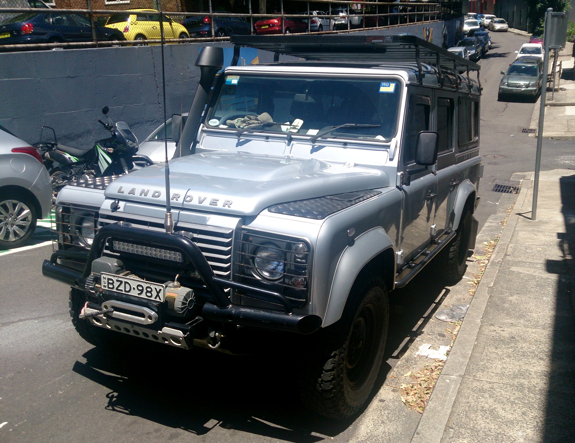 a silver suv parked on the side of the road