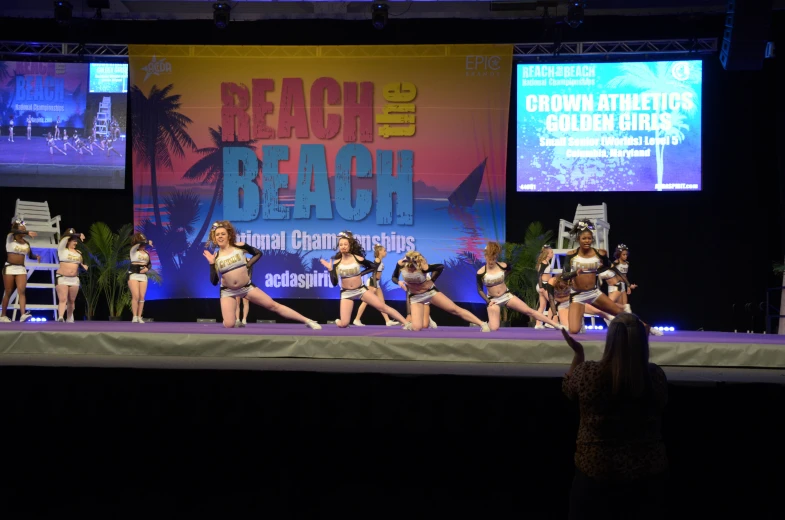 girls performing on stage in matching bathing suits