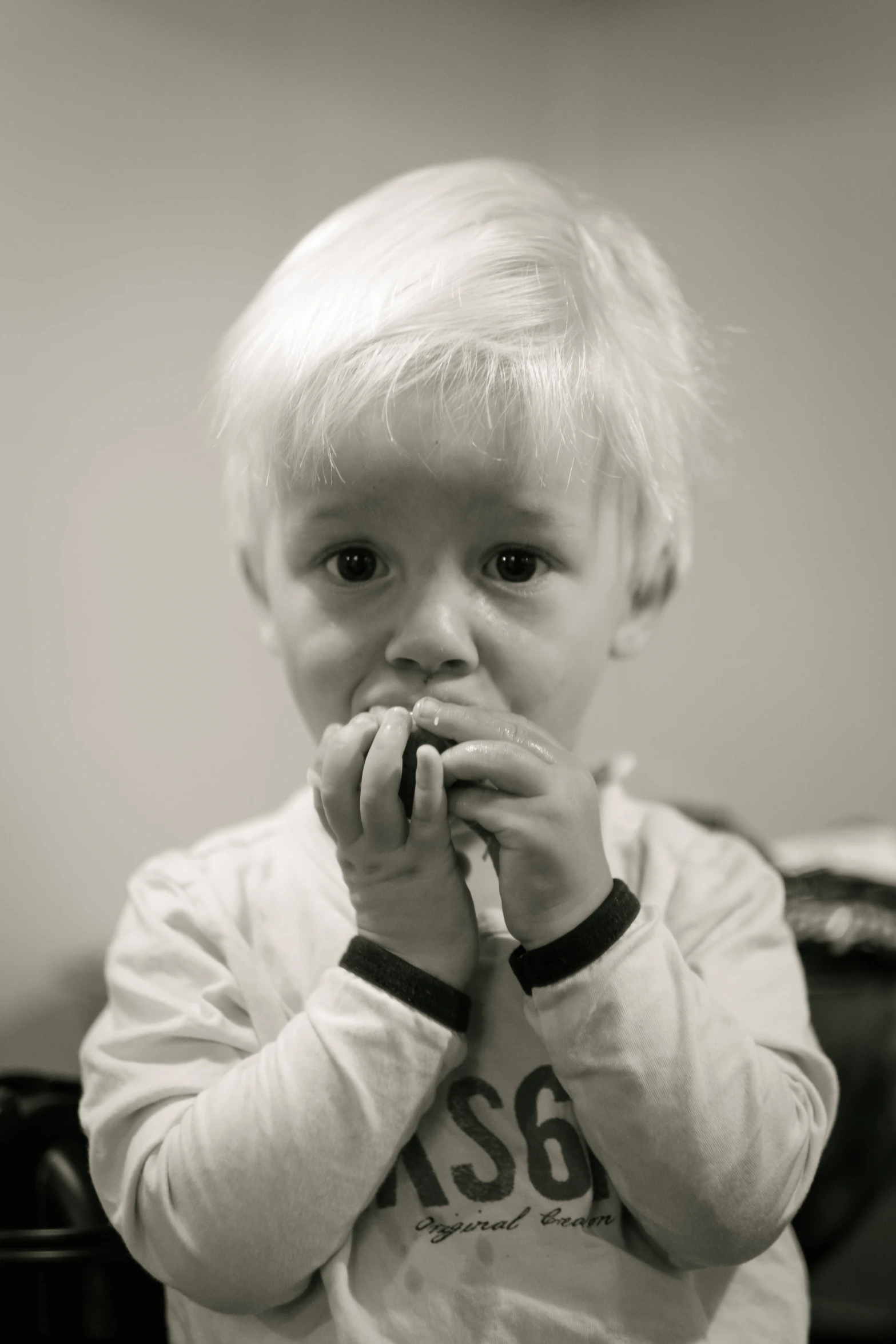 a little boy holding soing with his hands