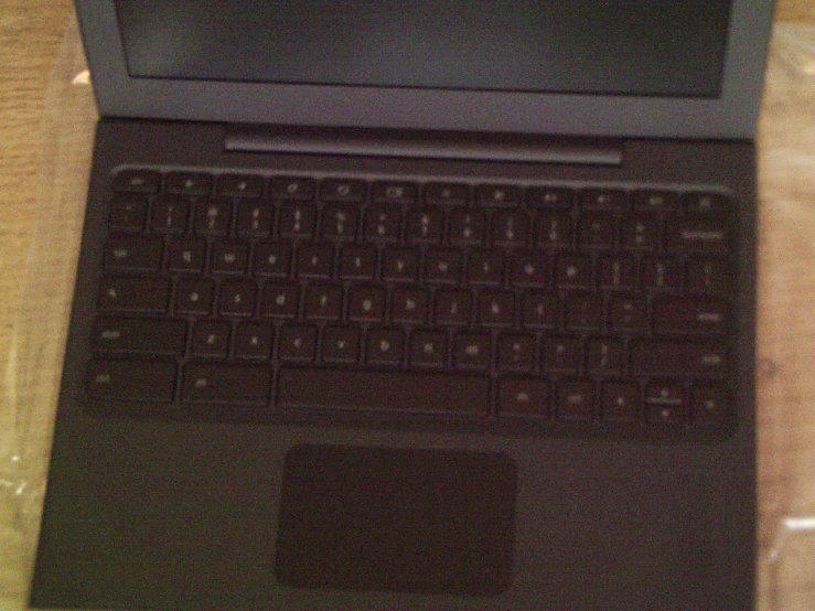 a laptop computer with a brown keyboard sitting on top of a desk