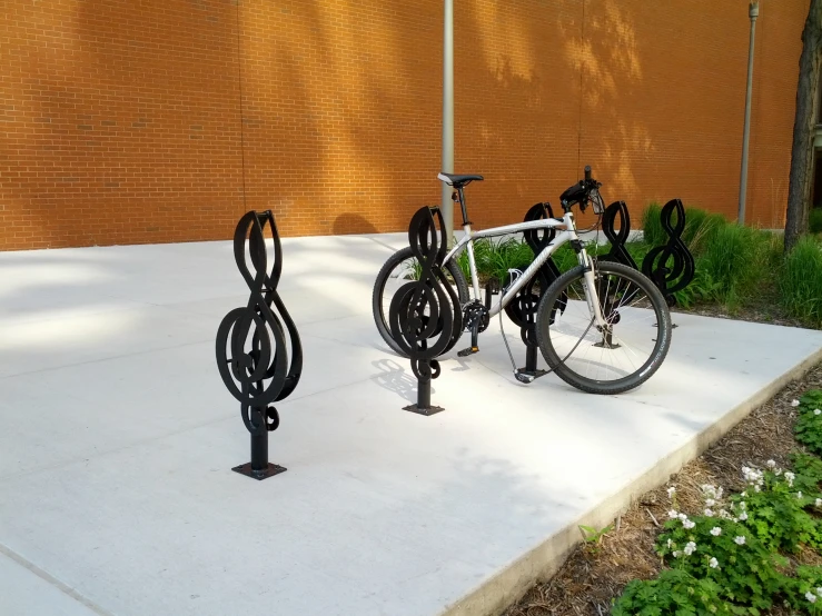 the three bikes are on the ground next to a wall