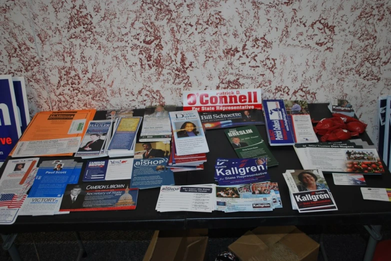 a large pile of pamphlets sitting on top of a table