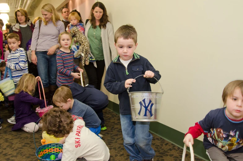 a group of children are lined up to see what's on the wall