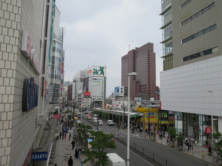 a city street with tall buildings and cars