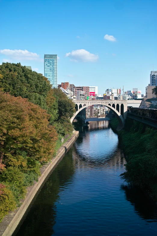 a canal flowing under a bridge with many traffic signs