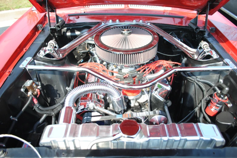 the engine of an old mustang muscle car